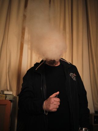 Shaun Ryder obscured by a cloud of smoke from his vape